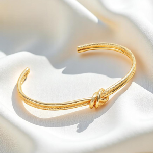 Gold Tone Textured Knot Cuff Bracelet - Image 1