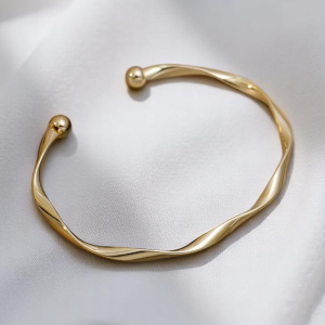 Gold Tone Twisted Open Cuff Bracelet - Image 1